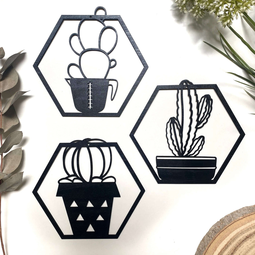 Trio de cactus cortados mediante láser y pintados en negro a mano con forma hexagonal.